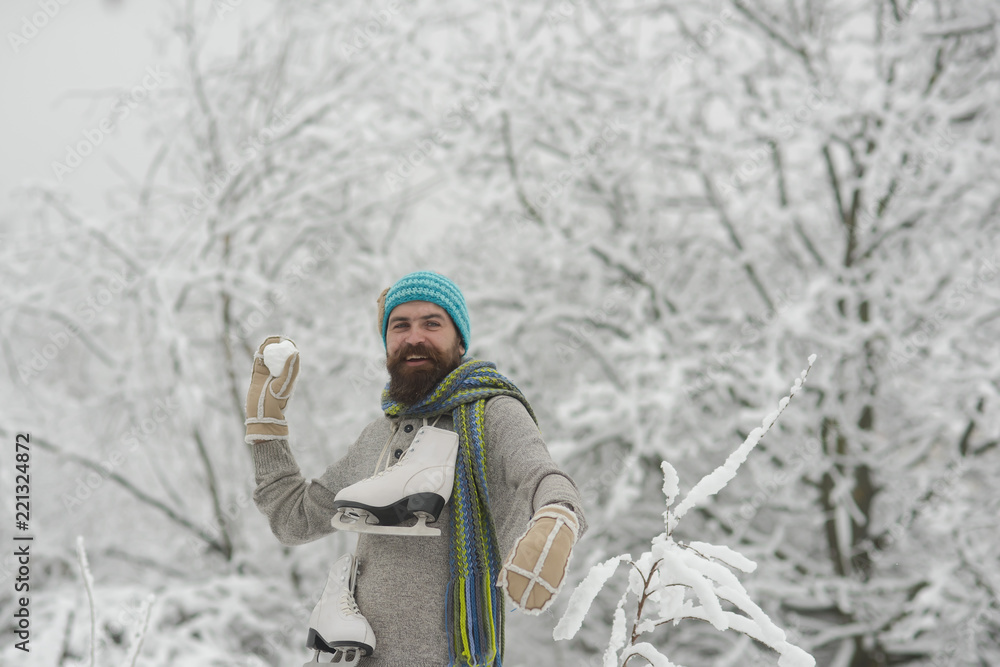 bearded happy man hold skate in snowy winter forest, christmas bearded happy man hold skate in snowy winter forest, christmas