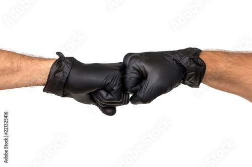 Two male hands in rubber gloves are clenched into fists. Isolate on white background. The concept of confrontation between two professionals