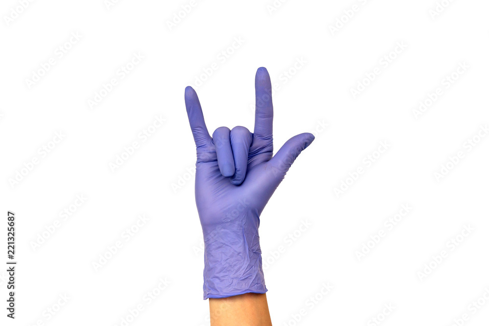 Obraz premium Isolate woman's hand showing two fingers in a lilac rubber glove on a white background. Gesture that rocks or horns. The concept of successful work of a chef of a surgeon or cleaning