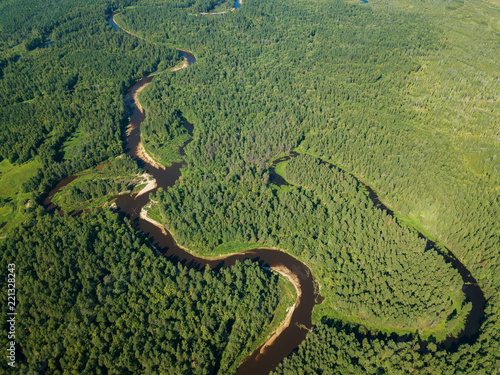 Aerial drone view  the bend of the river with sandy stretches of deep forest on a Sunny day.