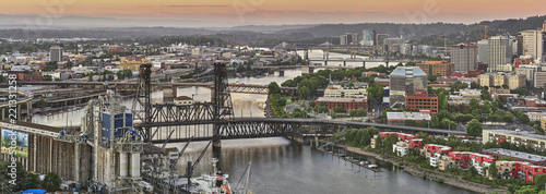 Drone aerial looking over an industrial area towards downtown Portland Oregon at sunrise