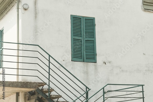 Isolated green wondow of a white house (Pesaro, Italy, Europe) photo