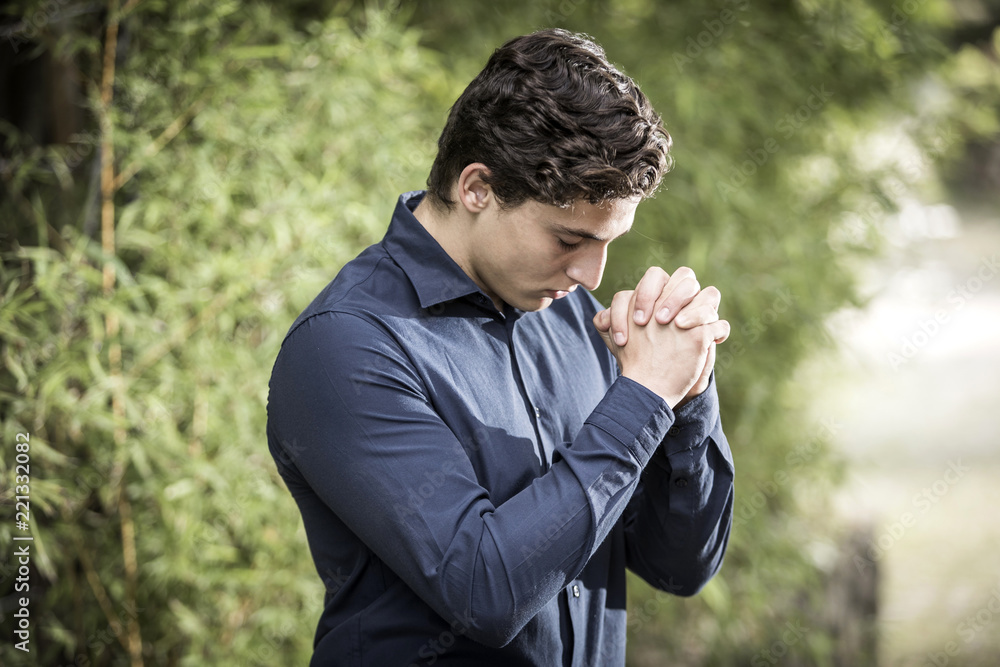 Businessman praying outdoor