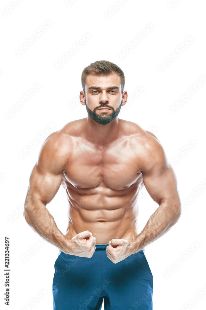 bodybuilder posing. Beautiful sporty guy male power. Fitness muscled in blue shorts. on isolated white background. Man with muscular torso. Strong Athletic Man Fitness Model Torso showing six pack abs