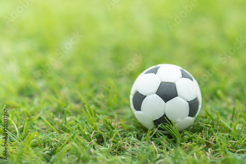 Sport Concept. Close up of mini football (Soccer) toy on green grass. © Montri Thipsorn