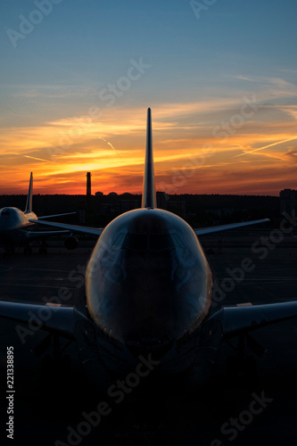 sunset in the city airport with airplane on front