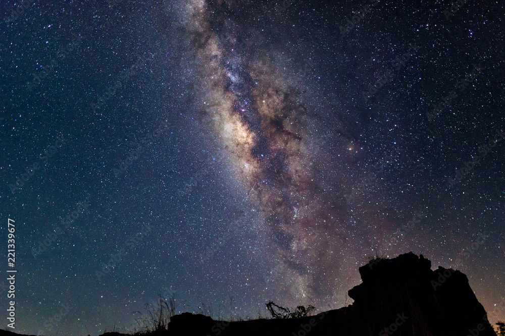 Milky way vertical on sky over blackground black mountain Milky way vertical on sky over blackground black mountain
