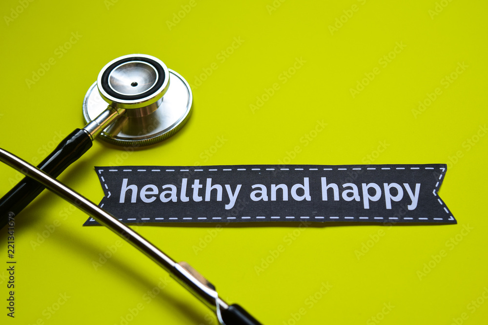 Closeup Healthy and happy with stethoscope concept inspiration on yellow background Closeup Healthy and happy with stethoscope concept inspiration on yellow background