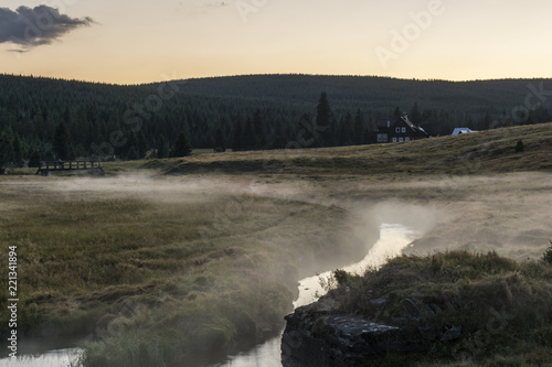 Evening view on the mountain landscape where there are fog above brook. The area "Jizerské hory" hamlet "Jizerka".