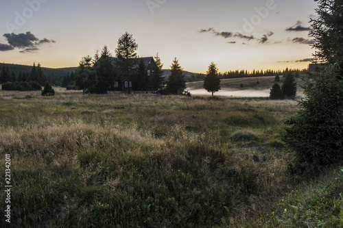 Evening view on the mountain landscape where there are fog above brook. The area "Jizerské hory" hamlet "Jizerka".