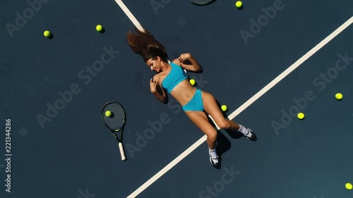 the girl in sports lingerie on the tennis court top view. photo
