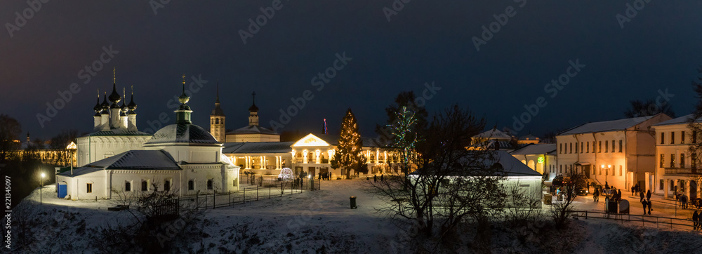 Suzdal, Russia. Pyatnitskaya church and Shopping arcade Gostiny Dvor of Suzdal Kremlin at night in winter