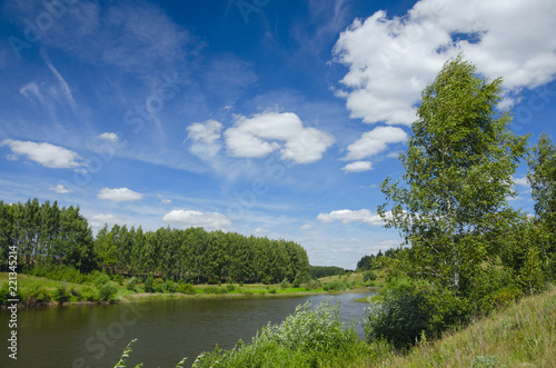 Fototapeta Naklejka Na Ścianę i Meble -  Sunny summer landscape with river,green hills and beautiful clouds in blue sky.Tula region,Russia. 