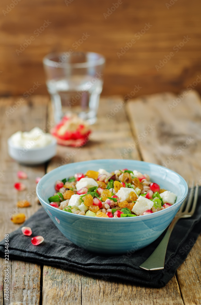 Barley pomegranate raisins feta salad in a bowl Barley pomegranate raisins feta salad in a bowl
