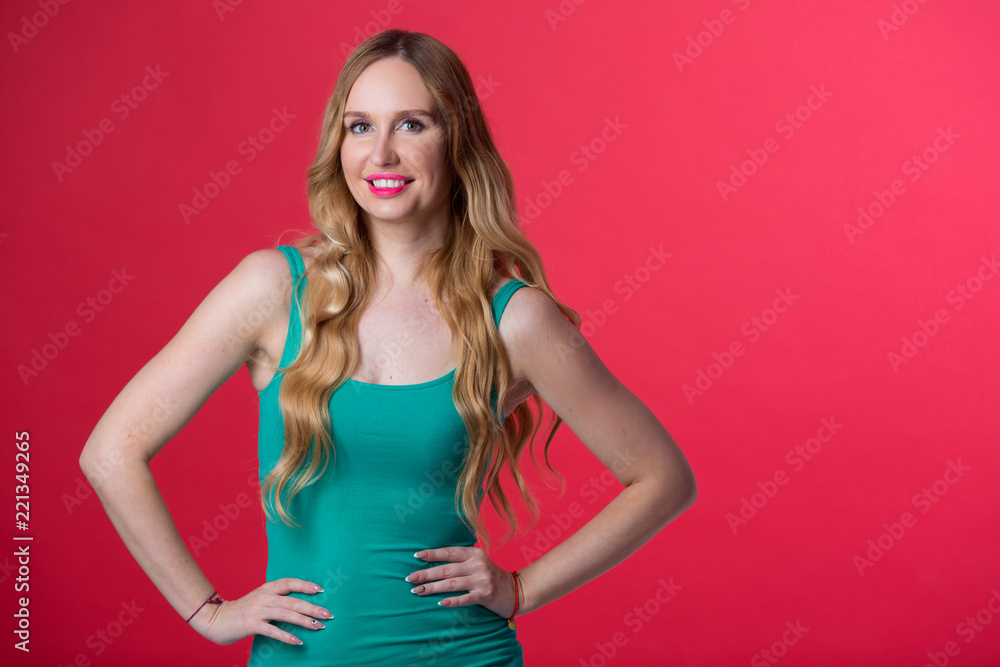 beautiful young girl with her hair on a red background
