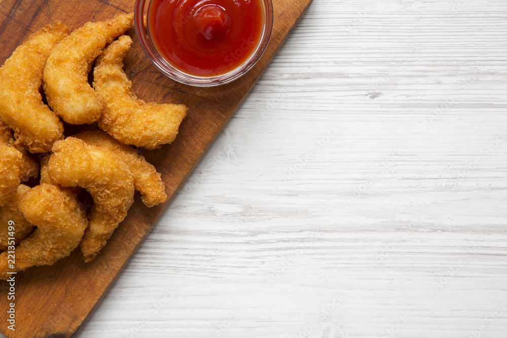 Fried shrimps tempura with sauce on wooden board over white wooden background, overhead view. Copy space. Fried shrimps tempura with sauce on wooden board over white wooden background, overhead view. Copy space.
