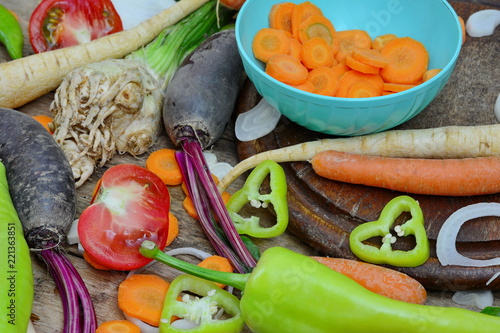 Mix of fresh farmers market vegetable from above on the old wooden board. Healthy eating background. Top view  photo