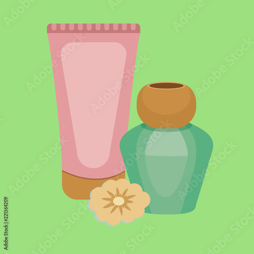 Bottles of cosmetic products and flower
