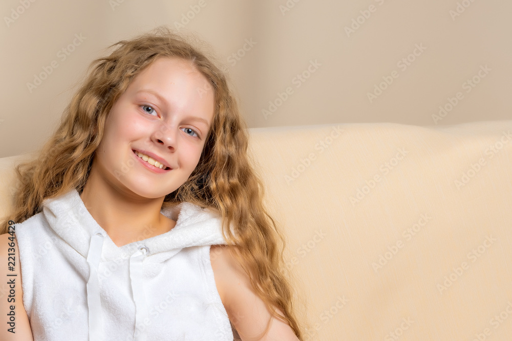 Little girl is sitting on the couch Little girl is sitting on the couch