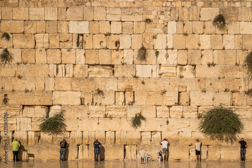Jews praying at the Wailing Wall. The Western Wall, called Wailing Wall or Kotel, is a surviving remnant of the Temple Mount and the holiest place for Jews photo
