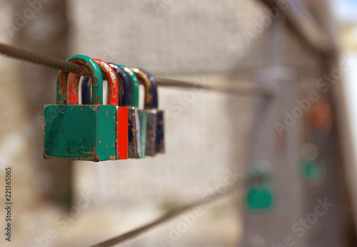 Love padlocks on the railing of a bridge.