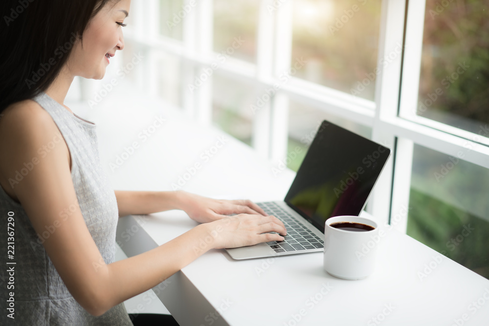 Woman using a laptop during a coffee break, hands close up Woman using a laptop during a coffee break, hands close up