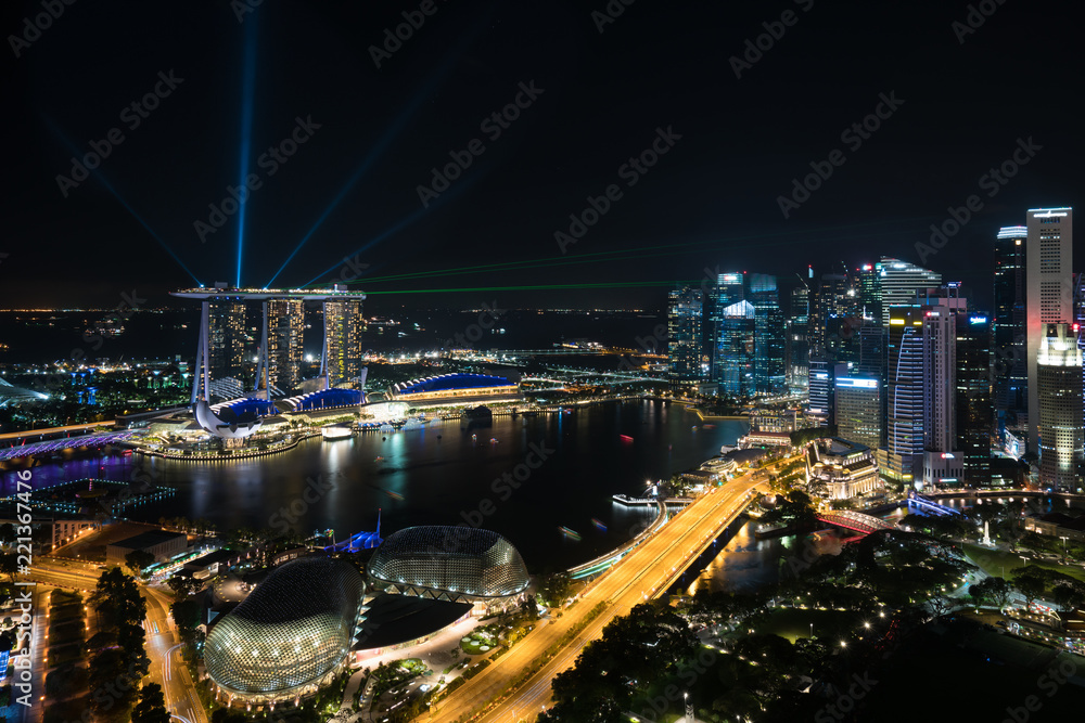 Fototapeta premium Colorful Singapore skyscraper building and laser show in night at Singapore.