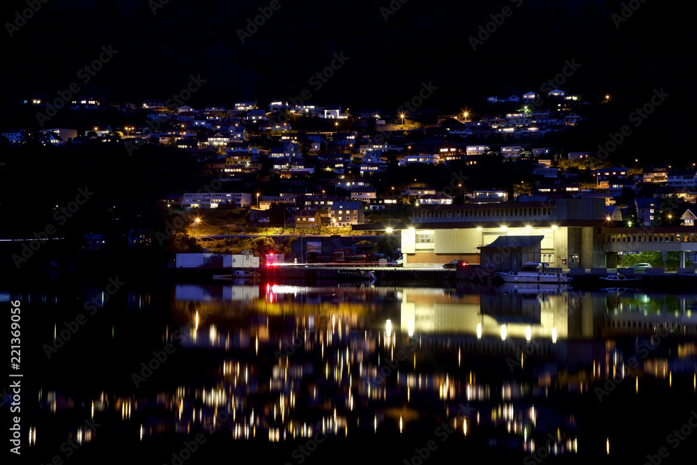 Night city Odda in the reflection of water. Norway