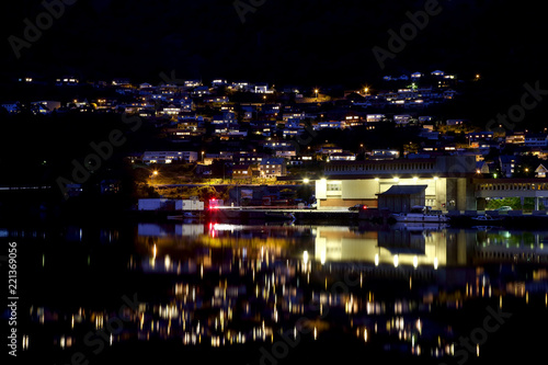 Night city Odda in the reflection of water. Norway