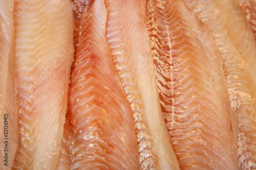 Cut fillet of red fish on the counter