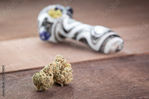 Εκτύπωση καμβά Marijuana buds on wood, with a packed cannabis smoking pipe in the background