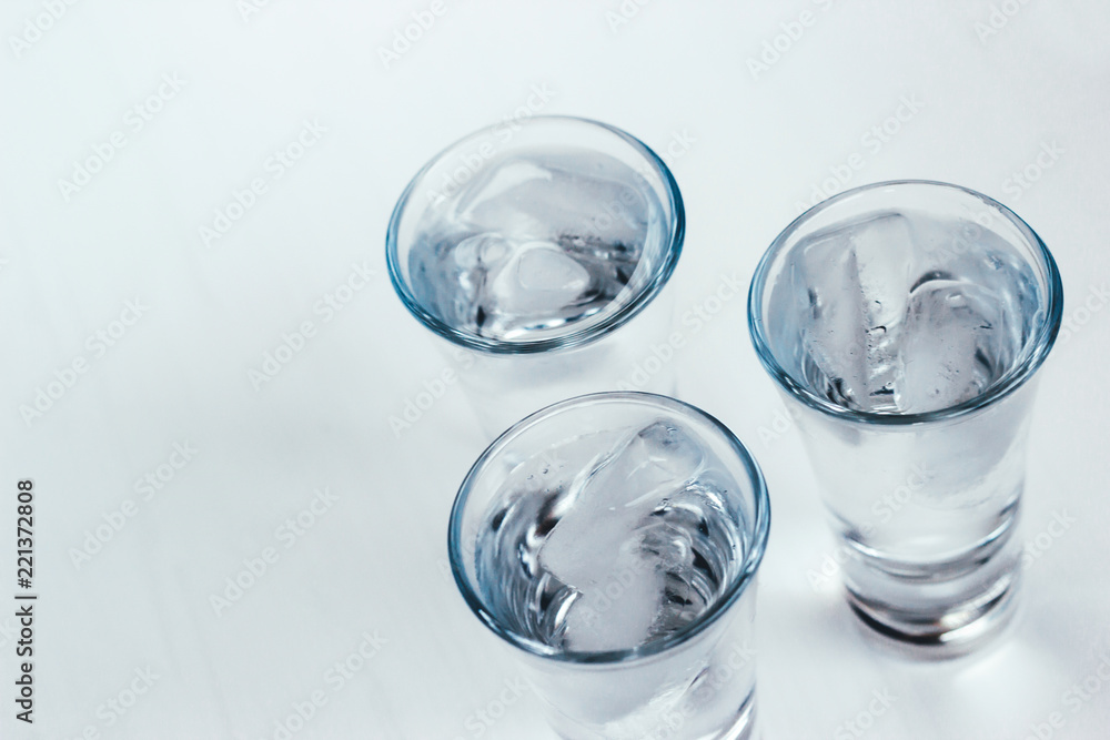 Vodka shots with ice on a white background Vodka shots with ice on a white background