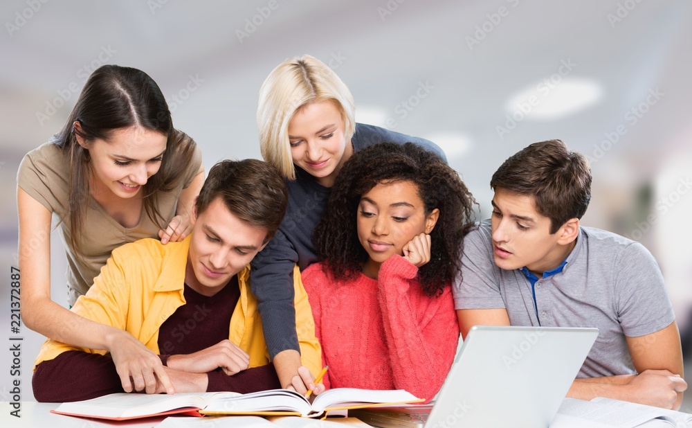 Four Young students studying subject on background Four Young students studying subject on background