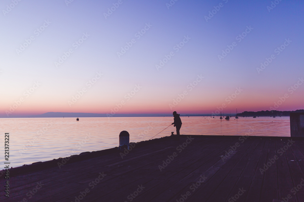 Fisherman fishing off the pier