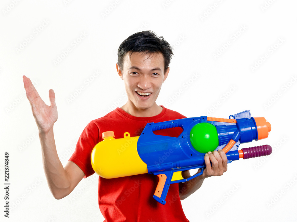 Young man with water gun toy Thailand Songkran Festival. Asian one person wear red short sleeves. isolated. Young man with water gun toy Thailand Songkran Festival. Asian one person wear red short sleeves. isolated.