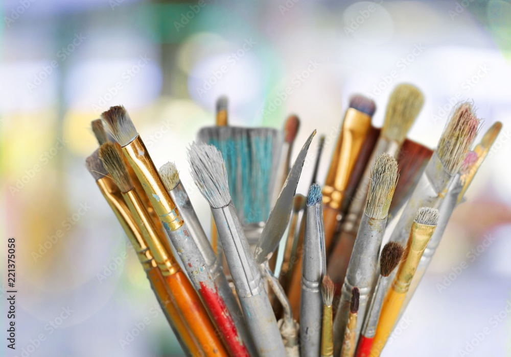 Row of artist paint brushes on background Row of artist paint brushes on background