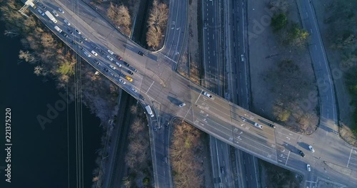 Top Down View of a Highway Junction and Train Tracks by River photo