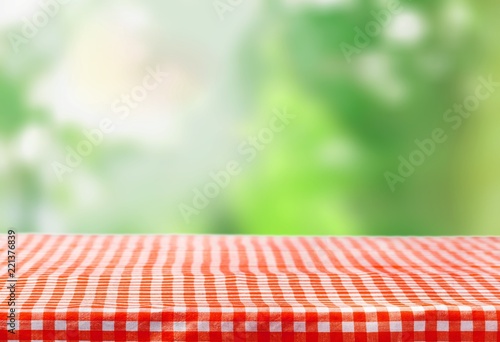 Checkered tablecloth on wooden table background