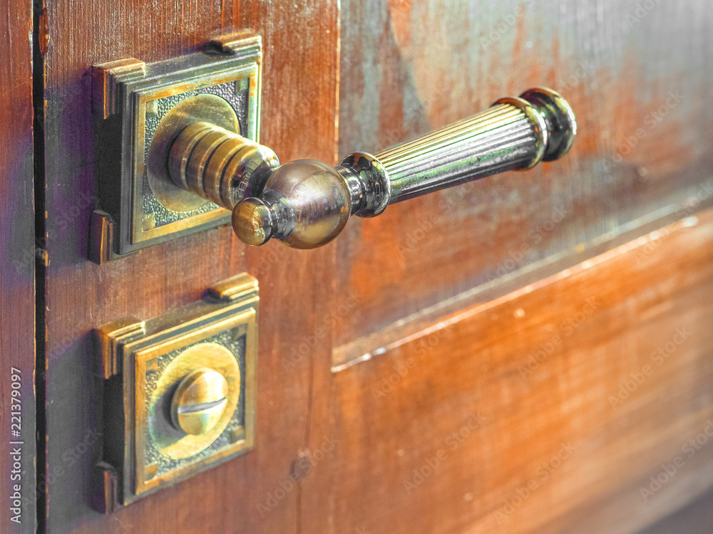 Old door knob on the wooden door. close up view Old door knob on the wooden door. close up view
