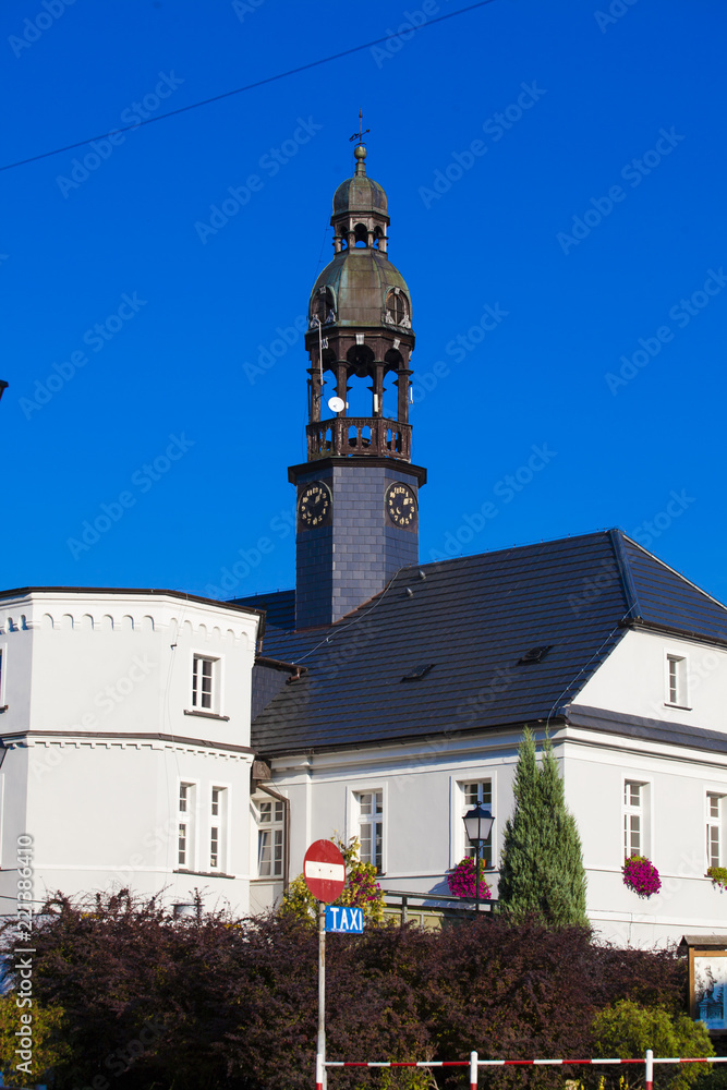 Road sign against the backdrop of City Hall in summer in Wlen in Poland