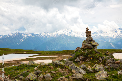 pyramid of stones on background of  mountain with snow © Aleksei Lazukov