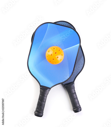 Pickleball paddle and ball on white