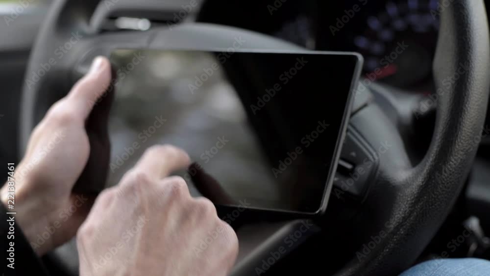 Man working with a tablet in the car Man working with a tablet in the car