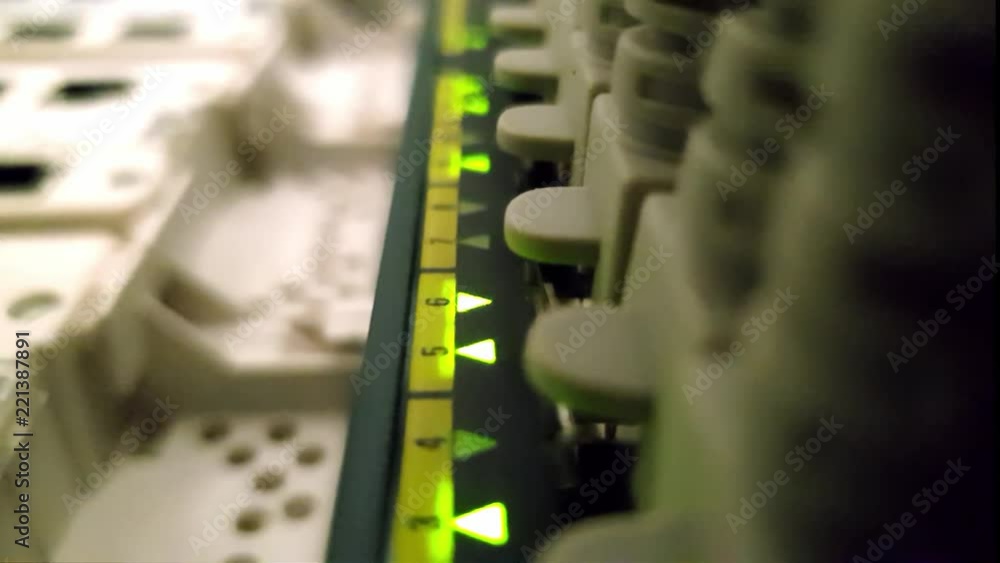 Blinking network ethernet active switch with connected cables in server room Blinking network ethernet active switch with connected cables in server room