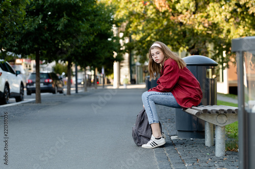 Young girl at bench in city