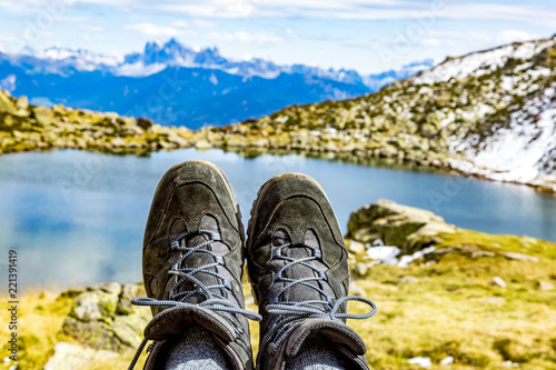 Hiking boots in the mountains in front of a lake
