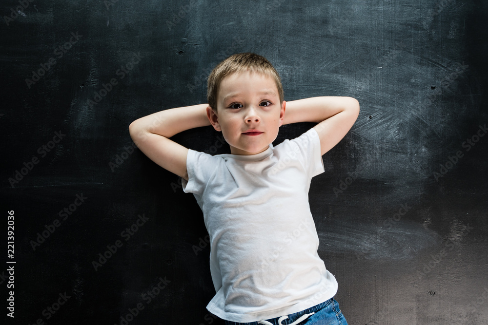 Young boy laying on the floor looking at camera. Creative design concept for 2019 calendar. Young boy laying on the floor looking at camera. Creative design concept for 2019 calendar.
