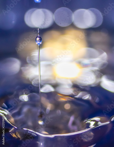 A small water drop fall on water surface and the splash jump to form a good clear, beautiful shape. 