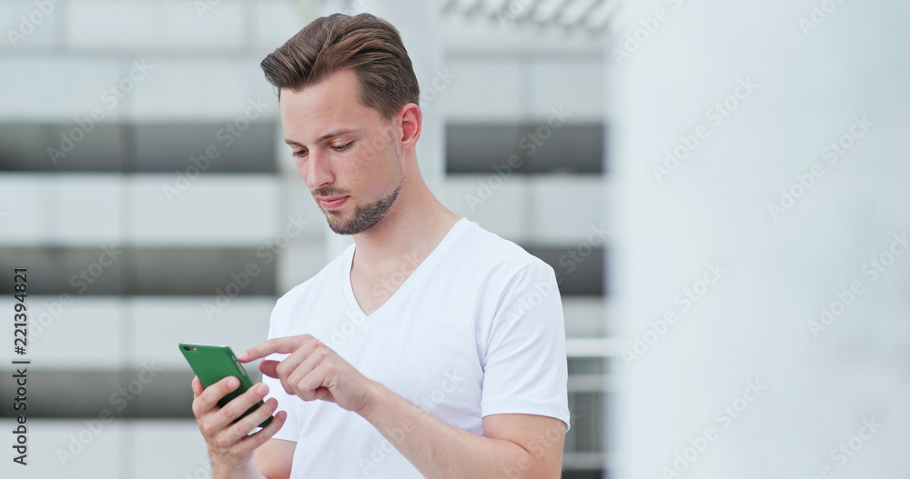 Caucasian man use of mobile phone in the city Caucasian man use of mobile phone in the city