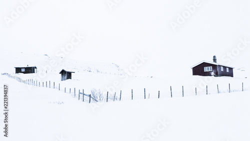 Winter log cabins in snow landscape in Norway